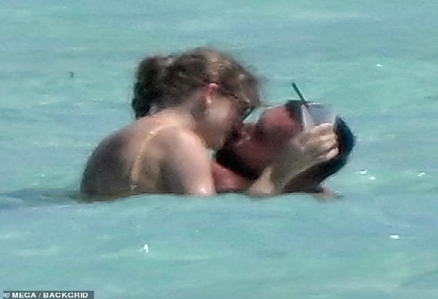 Breaking News: During a romantic trip to the Bahamas, Taylor Swift shares a passionate kiss with Travis Kelce while flaunting her incredibly toned physique in a tiny yellow bikini...