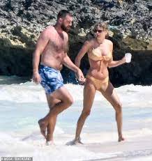 Breaking News: During a romantic trip to the Bahamas, Taylor Swift shares a passionate kiss with Travis Kelce while flaunting her incredibly toned physique in a tiny yellow bikini...